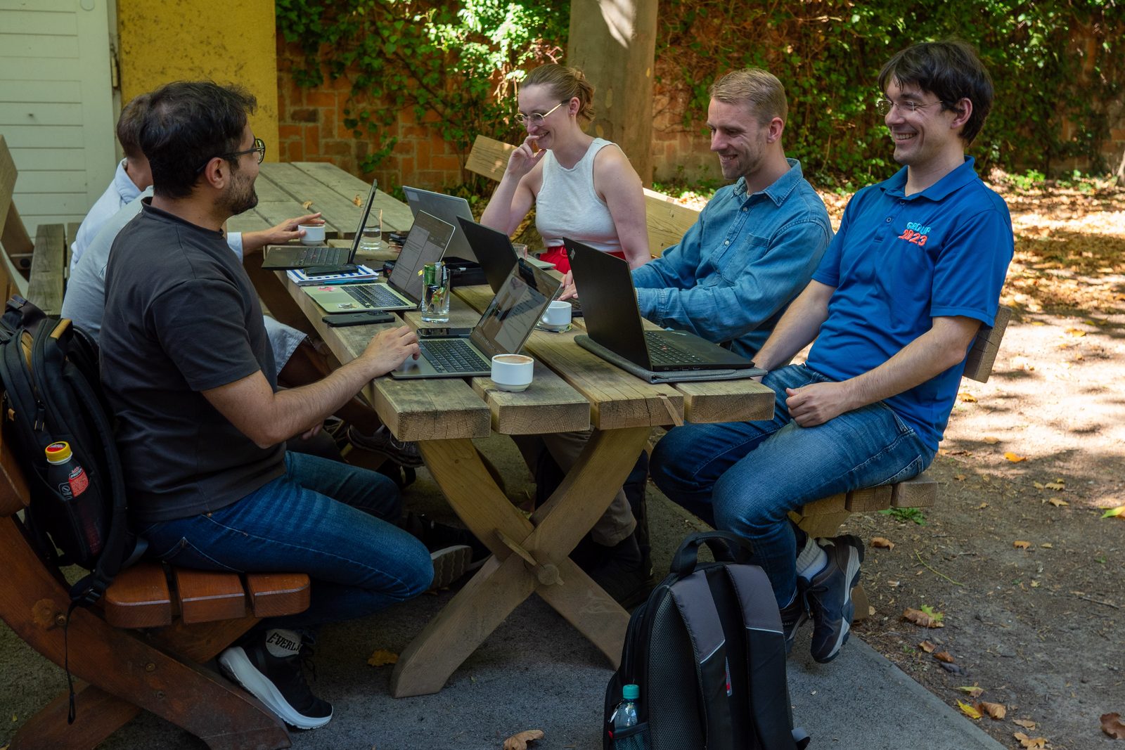 Group work on laptops in the courtyard