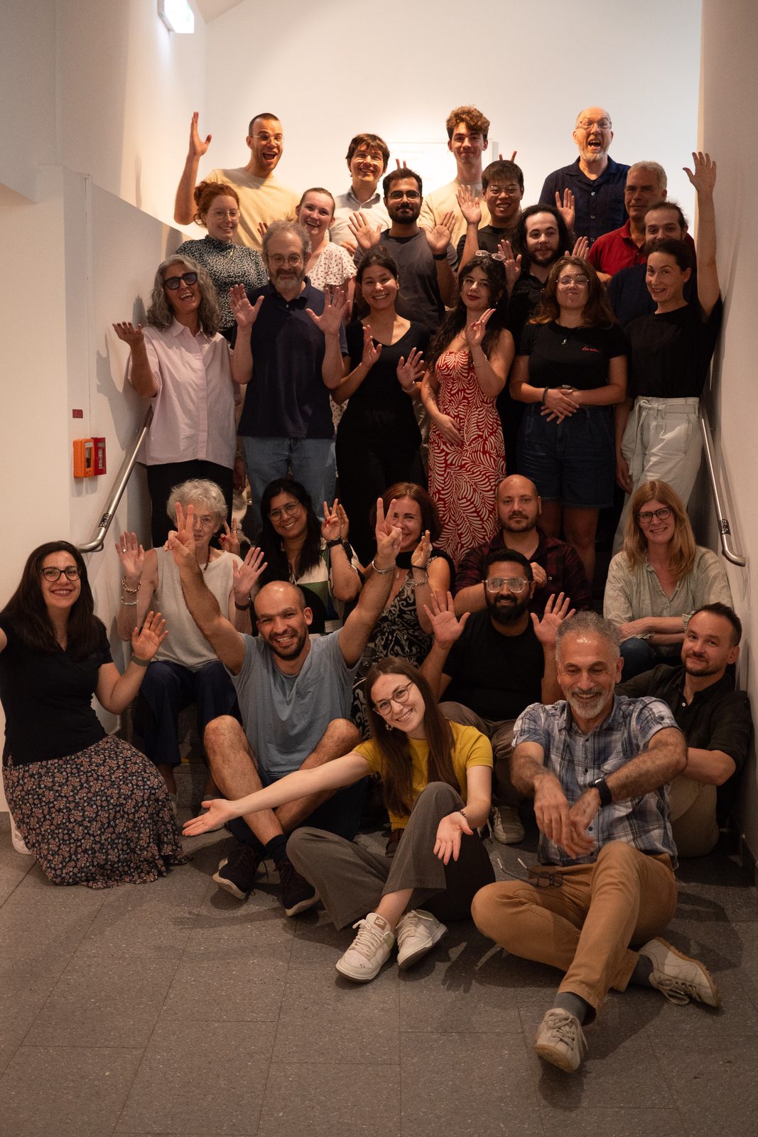 Group photo of the participants, waving